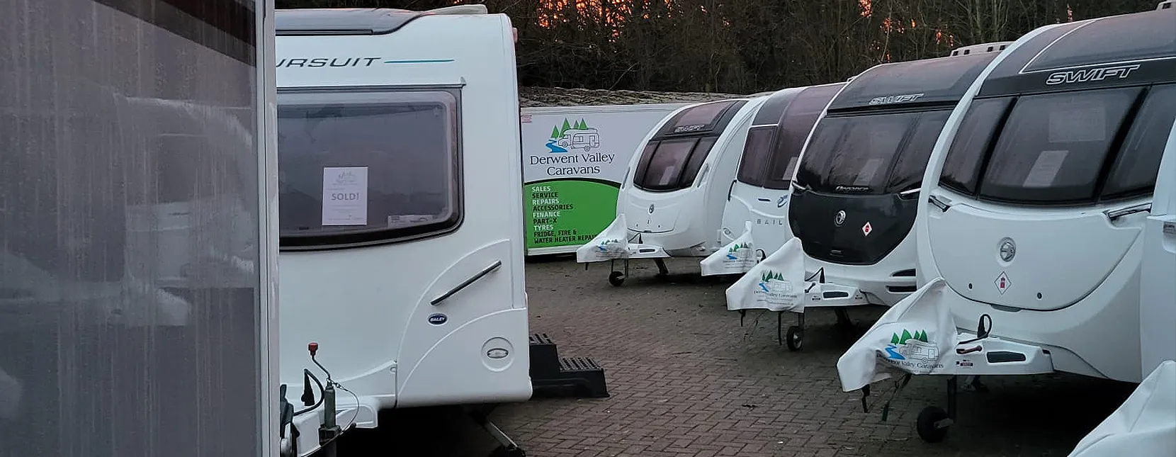 Caravans for sale in dealership yard photograph taken at dusk time for beautiful effect