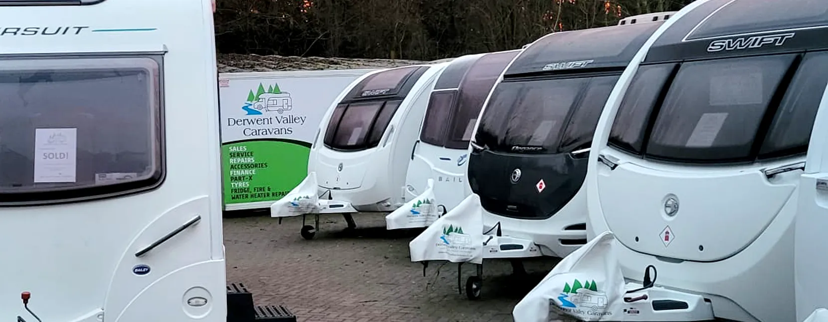 Caravans for sale in dealership yard photograph taken at dusk time for beautiful effect